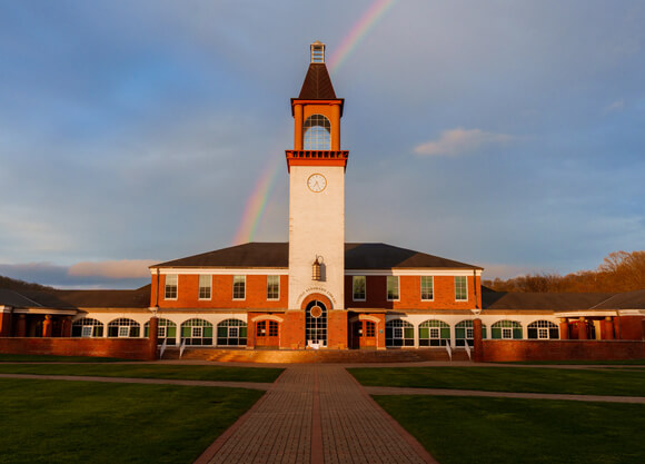 Rainbow behind the library clocktower on an autumn day